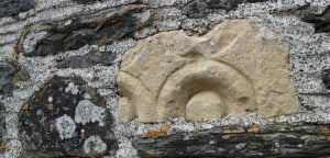A piece of Dundry Stone in the wall of a farm building at Strata Florida, Ceredigion